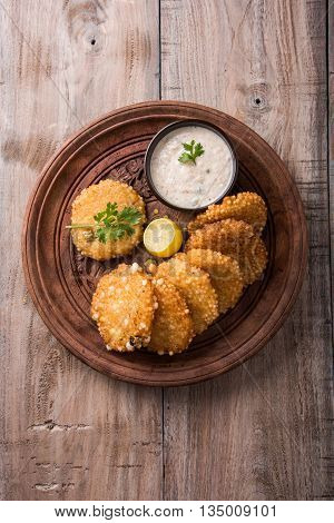 tasty sabudana vada or sabudana vade made up of Sago served with peanut chutney, a famous fasting recipe or snack from maharashtra, India