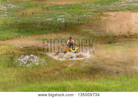 Off Road On 4X4 Quad Bike Through Mud Puddle