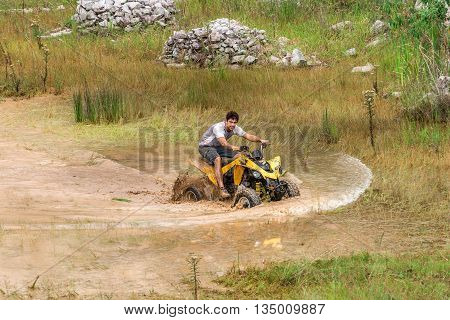 Off Road On 4X4 Quad Bike Through Mud Puddle