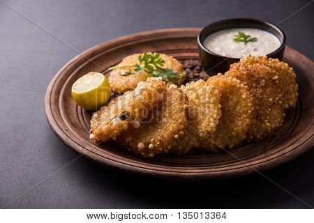 tasty sabudana vada or sabudana vade made up of Sago served with peanut chutney, a famous fasting recipe or snack from maharashtra, India