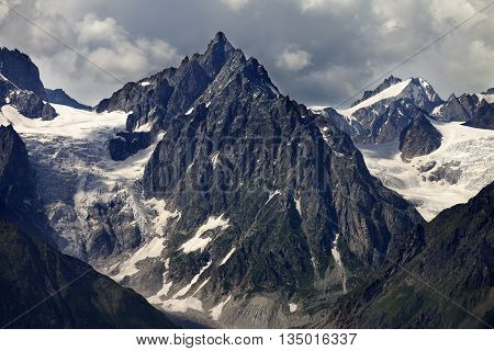 Mountains With Glacier In Clouds Before Rain