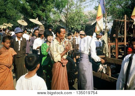 PAGAN / MYANMAR - CIRCA 1987: A man plays a wooden flute at a Buddhist parade in Pagan during a holiday.