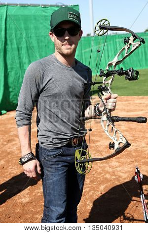 ARLINGTON, TX - APR 18: Recording artist Justin Moore poses at the ACM & Cabela's Great Outdoor Archery Event at the Texas Rangers Youth Ballpark on April 18, 2015.