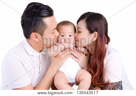 Asian parent kiss their six months old baby boy