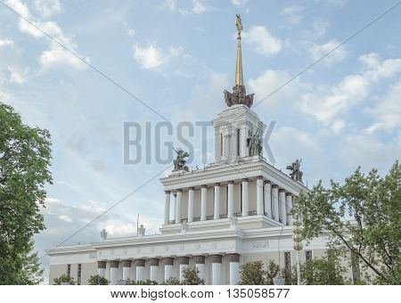 Old building with columns and sculptures on the eaves in the park