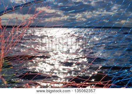 Underwater fragment of an old fishing net Spoon fishing over the water