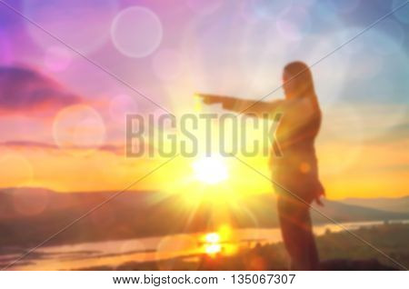 Abstract Blurred and soft photo of Women on hilltop with bokeh of sunrise on the natural background