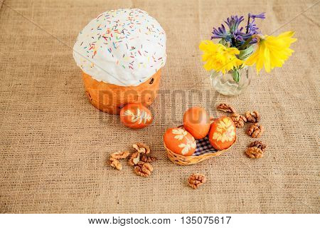 Homemade Easter cake and painted eggs on the table