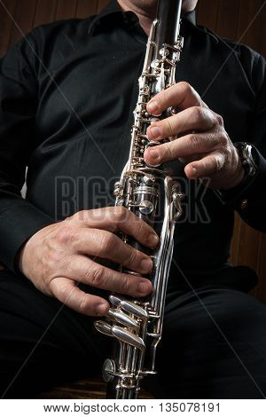 hands of a clarinet player in black