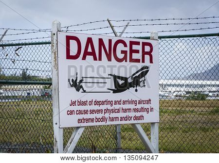Warning sign at airport on Saint Martin island near Moho beach