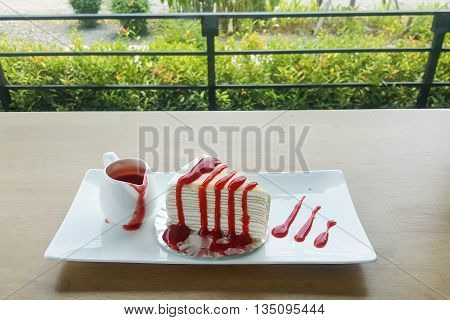 crepe cake strawberry on wood table coffee shop