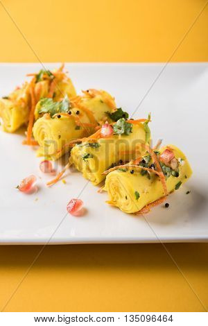 khandvi is a gujarati snack from India which is made with gram flour and curds tempered with sesame seeds and mustard seeds also known as Surali chya Vadya/Stuffed Khandvi, selective focus