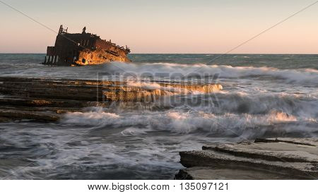 Shipwreck of an abandoned ship on a rocky coast at Akrotiri Beach in Cyprus