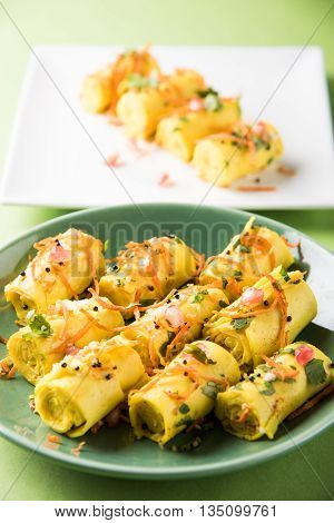 khandvi is a gujarati snack from India which is made with gram flour and curds tempered with sesame seeds and mustard seeds also known as Surali chya Vadya/Stuffed Khandvi, selective focus
