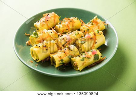 khandvi is a gujarati snack from India which is made with gram flour and curds tempered with sesame seeds and mustard seeds also known as Surali chya Vadya/Stuffed Khandvi, selective focus