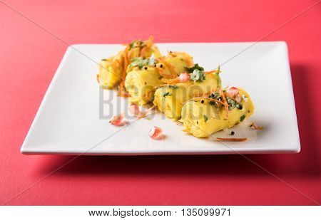 khandvi is a gujarati snack from India which is made with gram flour and curds tempered with sesame seeds and mustard seeds also known as Surali chya Vadya/Stuffed Khandvi, selective focus