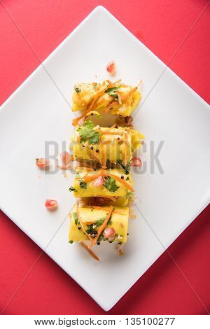 khandvi is a gujarati snack from India which is made with gram flour and curds tempered with sesame seeds and mustard seeds also known as Surali chya Vadya/Stuffed Khandvi, selective focus