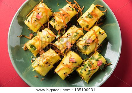 khandvi is a gujarati snack from India which is made with gram flour and curds tempered with sesame seeds and mustard seeds also known as Surali chya Vadya/Stuffed Khandvi, selective focus