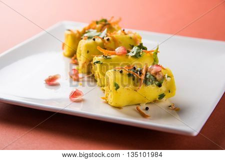 khandvi is a gujarati snack from India which is made with gram flour and curds tempered with sesame seeds and mustard seeds also known as Surali chya Vadya/Stuffed Khandvi, selective focus