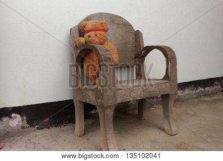 eddy bear siting on chair and toy teddy bear
