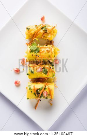 khandvi is a gujarati snack from India which is made with gram flour and curds tempered with sesame seeds and mustard seeds also known as Surali chya Vadya/Stuffed Khandvi, selective focus