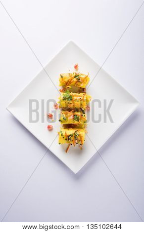 khandvi is a gujarati snack from India which is made with gram flour and curds tempered with sesame seeds and mustard seeds also known as Surali chya Vadya/Stuffed Khandvi, selective focus