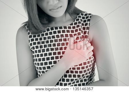 Woman is clutching her chest acute pain possible heart attack