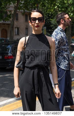 MILAN ITALY - JUNE 18: Fashionable woman poses outside Marni fashion show building for Milan Men's Fashion Week on JUNE 18 2016 in Milan.
