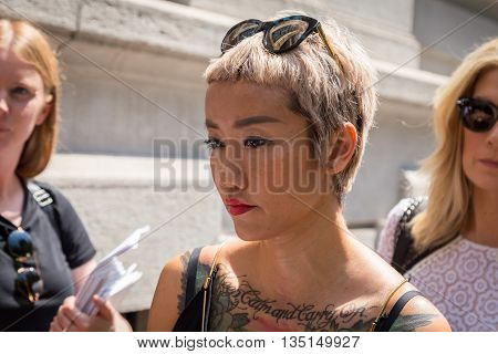 MILAN ITALY - JUNE 18: Fashionable woman poses outside Marni fashion show building for Milan Men's Fashion Week on JUNE 18 2016 in Milan.