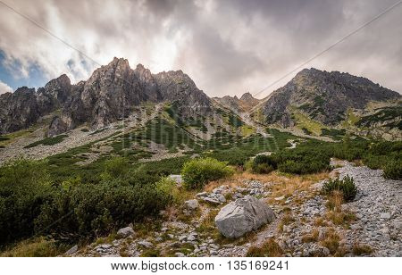 Mountain Landscape with Dramatic Glowing Sky and Sun Shining From Behind the Peaks. Mlynicka Valley High Tatra Slovakia.