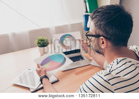 Back View Of Man In Glasses Looking On Diagramas