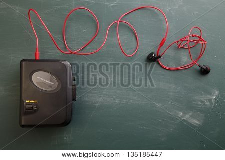 old Walkman on green background