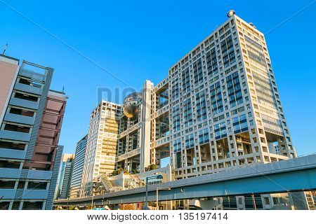 TOKYO JAPAN - NOVEMBER 27 2015: Fuji T.V. headquarters one of the most striking buildings in Japan. its' futuristic metallic clad building featuring a massive silver ball 32 metres in diameter