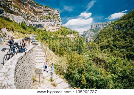 Verdon, France - June 29, 2015: Tourists descend the stone steps to the mountain river Le Verdon in the Verdon Gorge in south-eastern France. Provence-Alpes-Cote d'Azur.