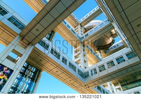 TOKYO JAPAN - NOVEMBER 27 2015: Fuji T.V. headquarters one of the most striking buildings in Japan. its' futuristic metallic clad building featuring a massive silver ball 32 metres in diameter