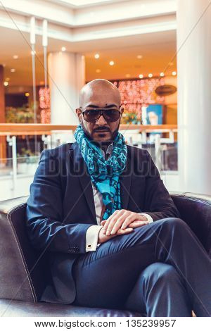 Arab businessman sitting on a sofa in an expensive hotel