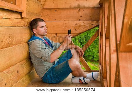 Young man holding mobile phone. Mountains. Communication conc