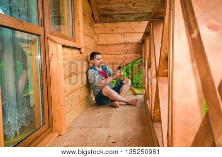 Young man using mobile phone. Mountains. Communication conc