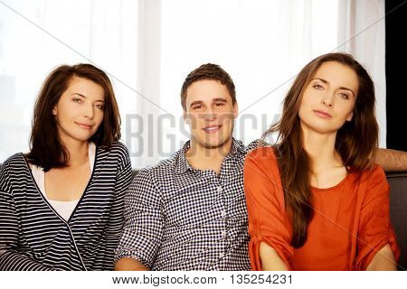 Sisters and brother relaxing at home.