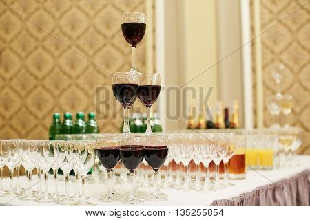 pyramid of glasses with red wine on table