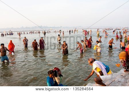 SANGAM, INDIA - JAN 27, 2013: Young and aged asian people come to the confluence of the Ganges and the Yamuna river during the biggest festival on Earth Kumbh Mela on January 27, 2013 in Allahabad, India