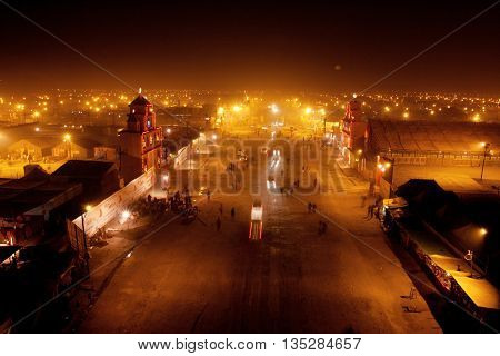 SANGAM, INDIA - JANUARY 26, 2013: Night street in the camp town near the confluence of the Ganges and the Yamuna during the biggest festival on Earth Kumbh Mela on January 26, 2013 in Allahabad, India.