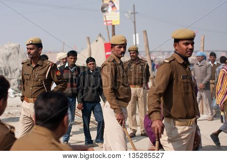 ALLAHABAD, INDIA - JAN 26, 2013: Indian policemen control of the situation at the biggest festival in the world - Kumbh Mela on January 26, 2013. It is held every 12 years at Sangam