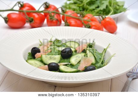 Delicious salad with salmon, olives and cucomber