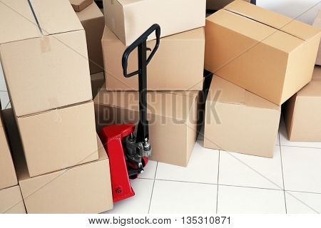 Manual pallet truck with carton boxes indoors