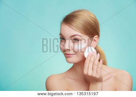 Woman Removing Makeup With Cream And Cotton Pad