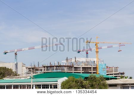 under construction building with the crane and the sky.