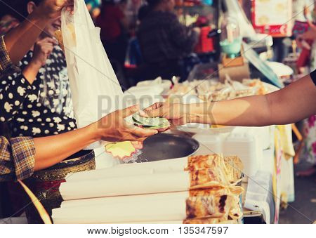 sale, retale, shopping and food concept - close up of hands giving money at street market