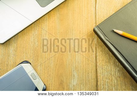 Topview shot of laptop and notepad on a desk