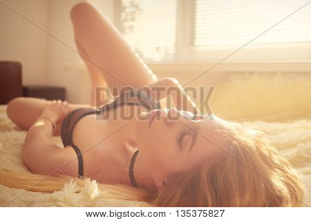sensual girl lying in sunlight toned image